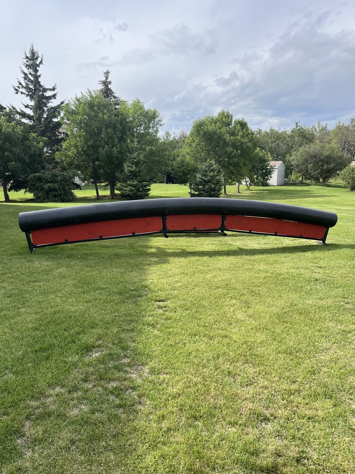 Red rainbow PVC rail feature on a grassy field