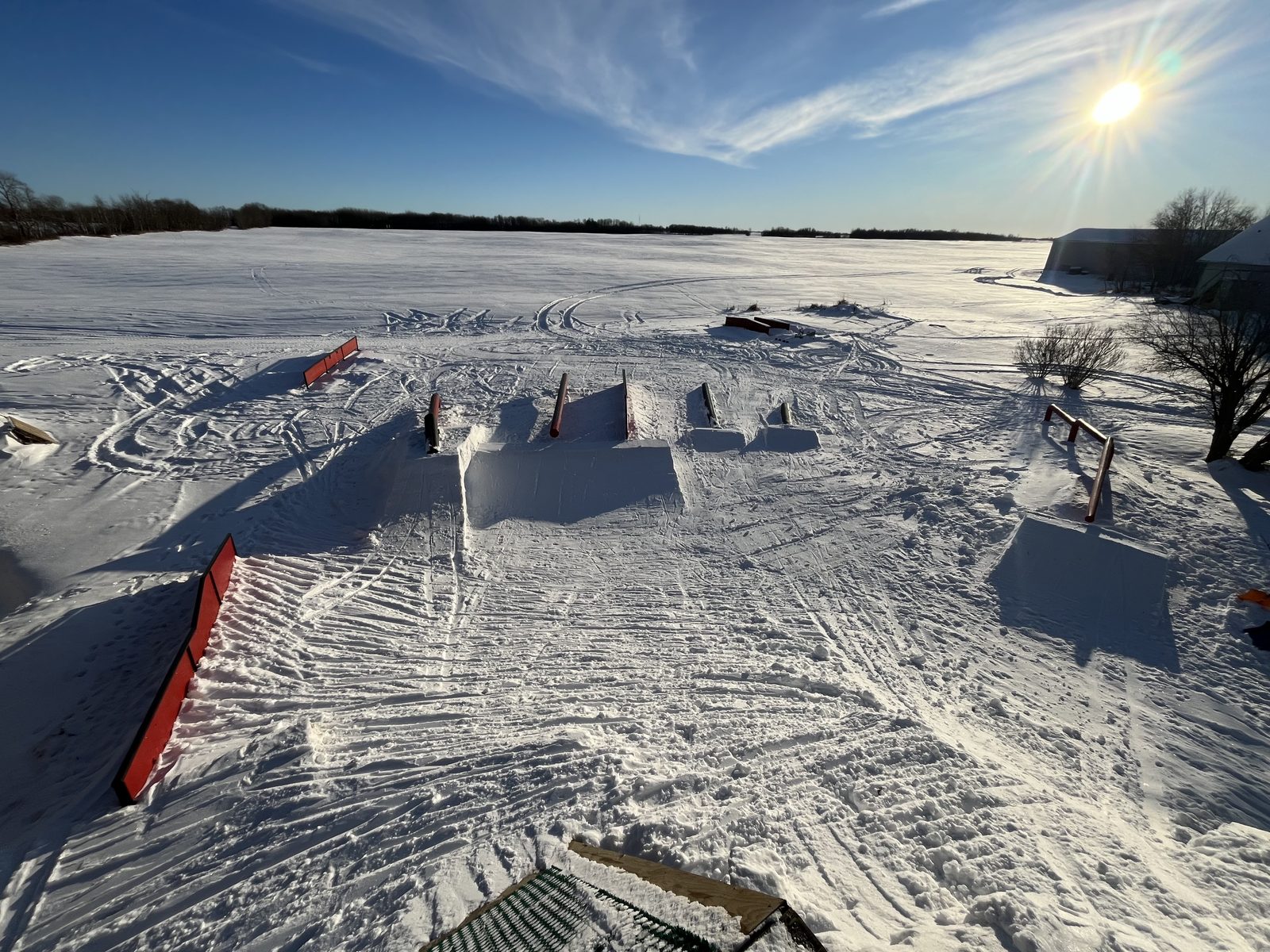 Overview of a terrain park with rails, boxes and jumps on snow